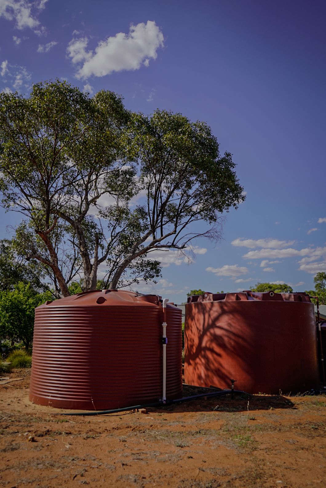 22,500ltr and 50,000ltr Round Poly Water Tanks in Heritage Red colour installed so that the tanks equalise